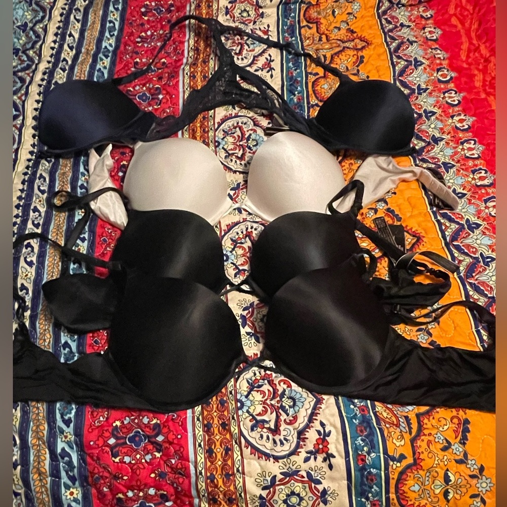 Victoria's Secret 34B Bombshell bras in blue, black, and white.